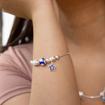 Pulsera tipo pd en plata ley 925 con dijes esferas azules y diamantados y estrella