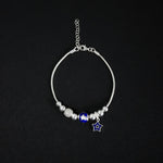 Pulsera tipo pd en plata ley 925 con dijes esferas azules y diamantados y estrella