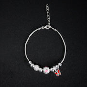Pulsera tipo pd en plata ley 925 con dijes esferas mariposas rojas y rosas, y diamantados