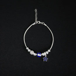 Pulsera tipo pd en plata ley 925 con dijes esferas azules y diamantados y estrella